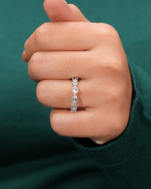 pear lab grown diamond eternity band worn on hand in white gold