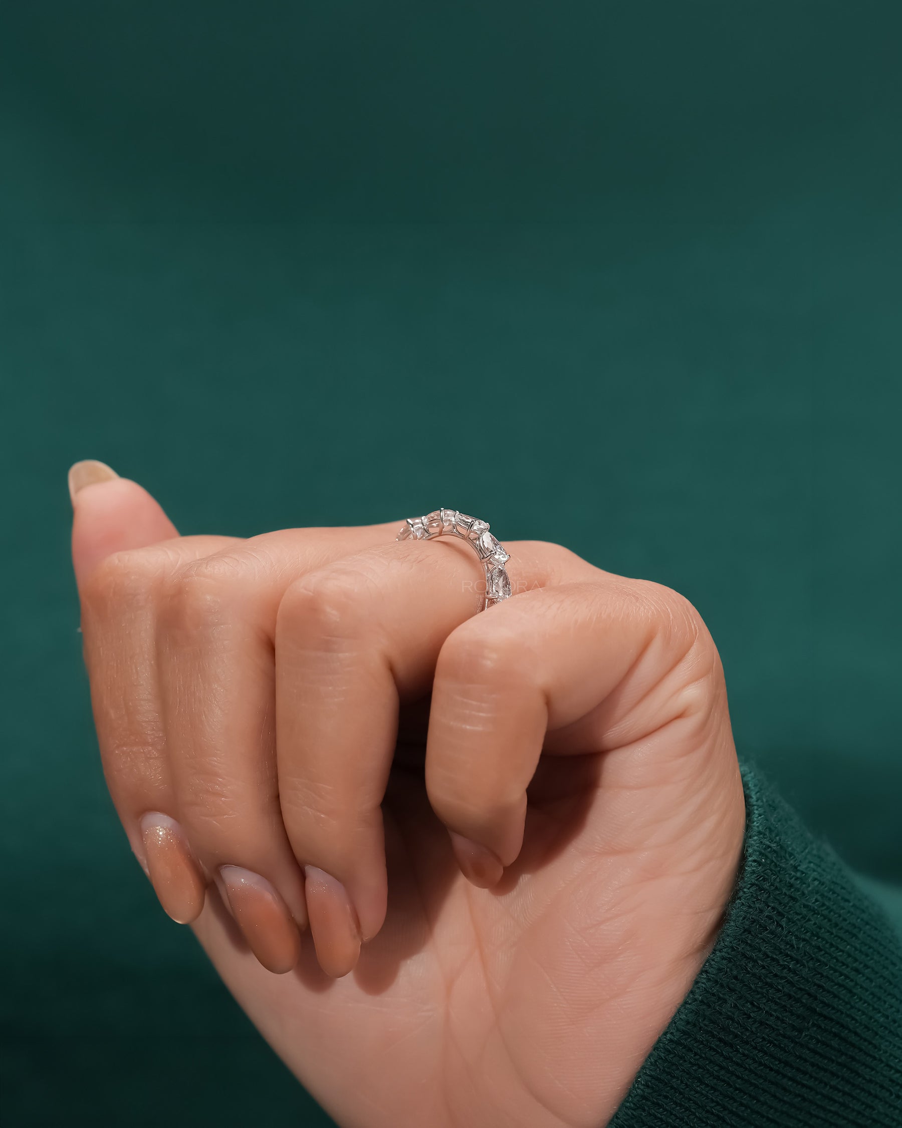 pear lab grown diamond eternity band worn with luxury styling in white gold