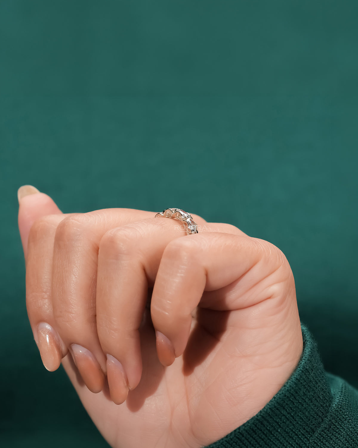 oval lab grown diamond eternity band worn with luxury styling in yellow gold
