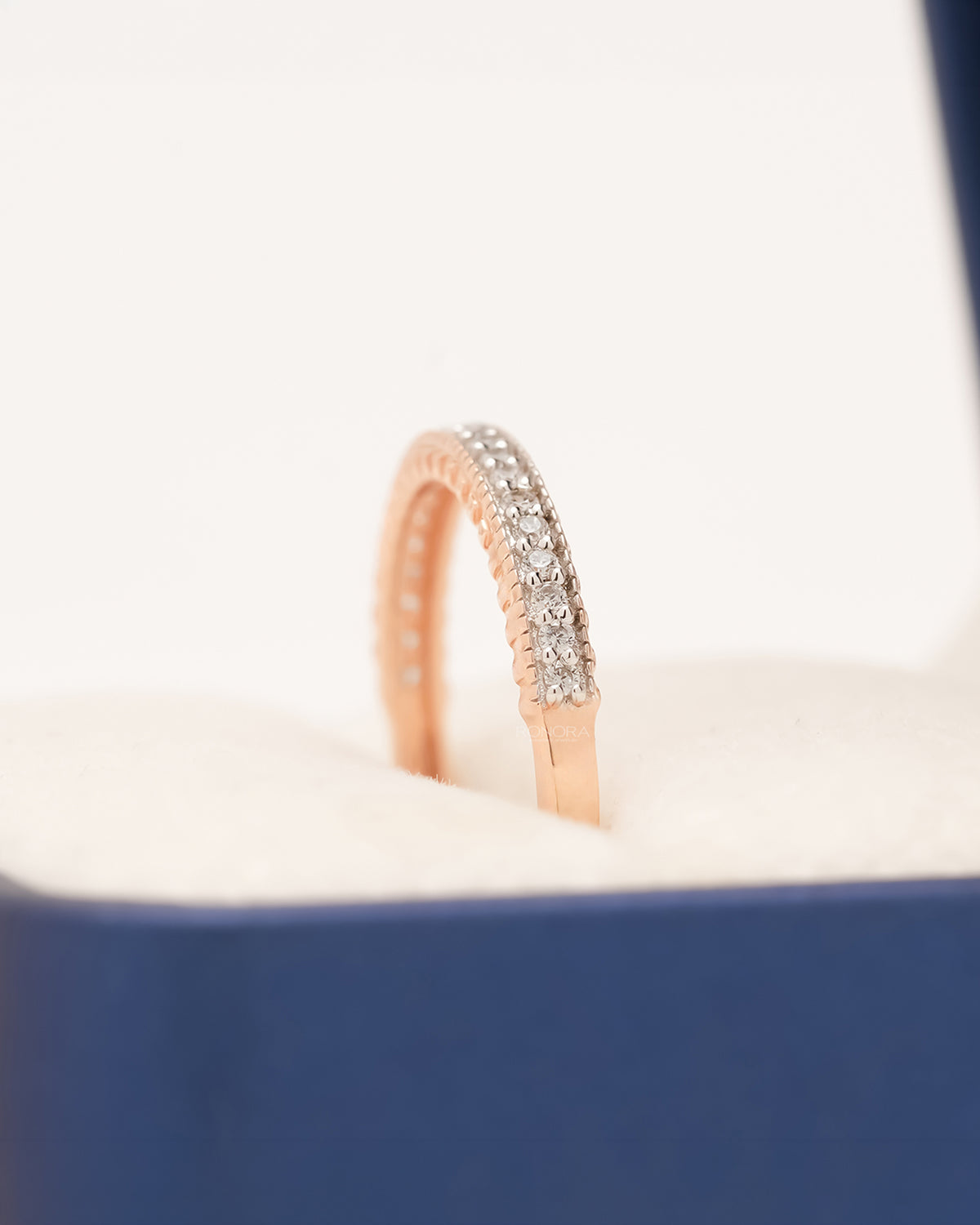 Side profile of rose gold double-row pavé band showing diamond setting
