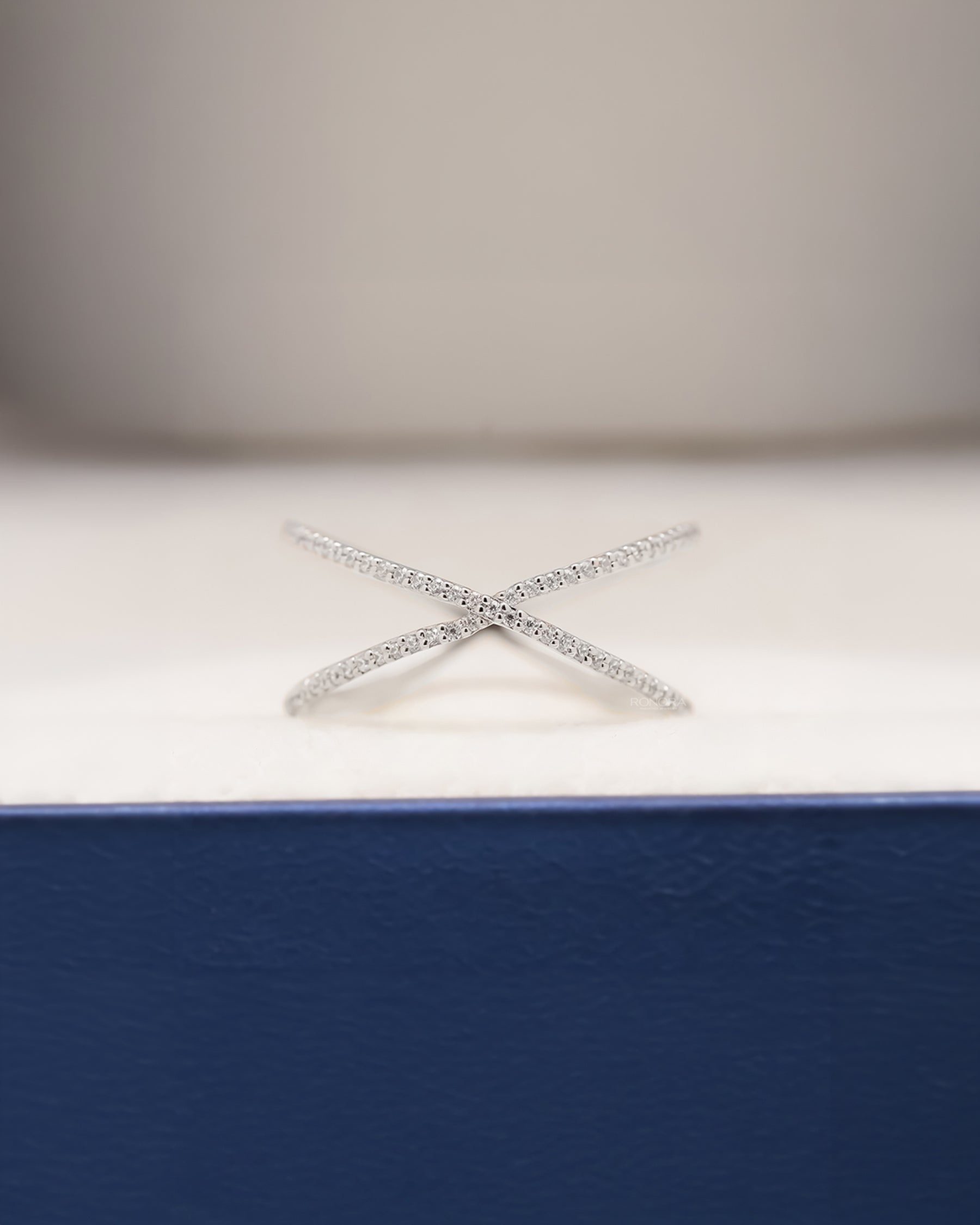 Aurelia white lab grown diamond pavé crossover ring inside Ronora box