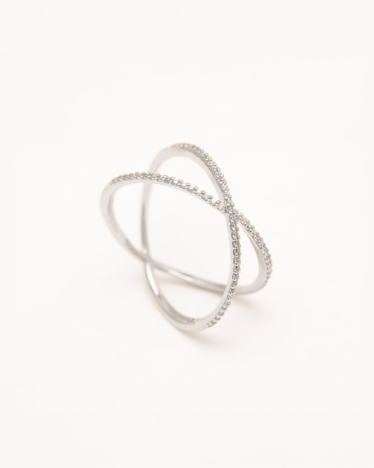 Back view of white lab grown diamond crossover ring showing sculptural open band