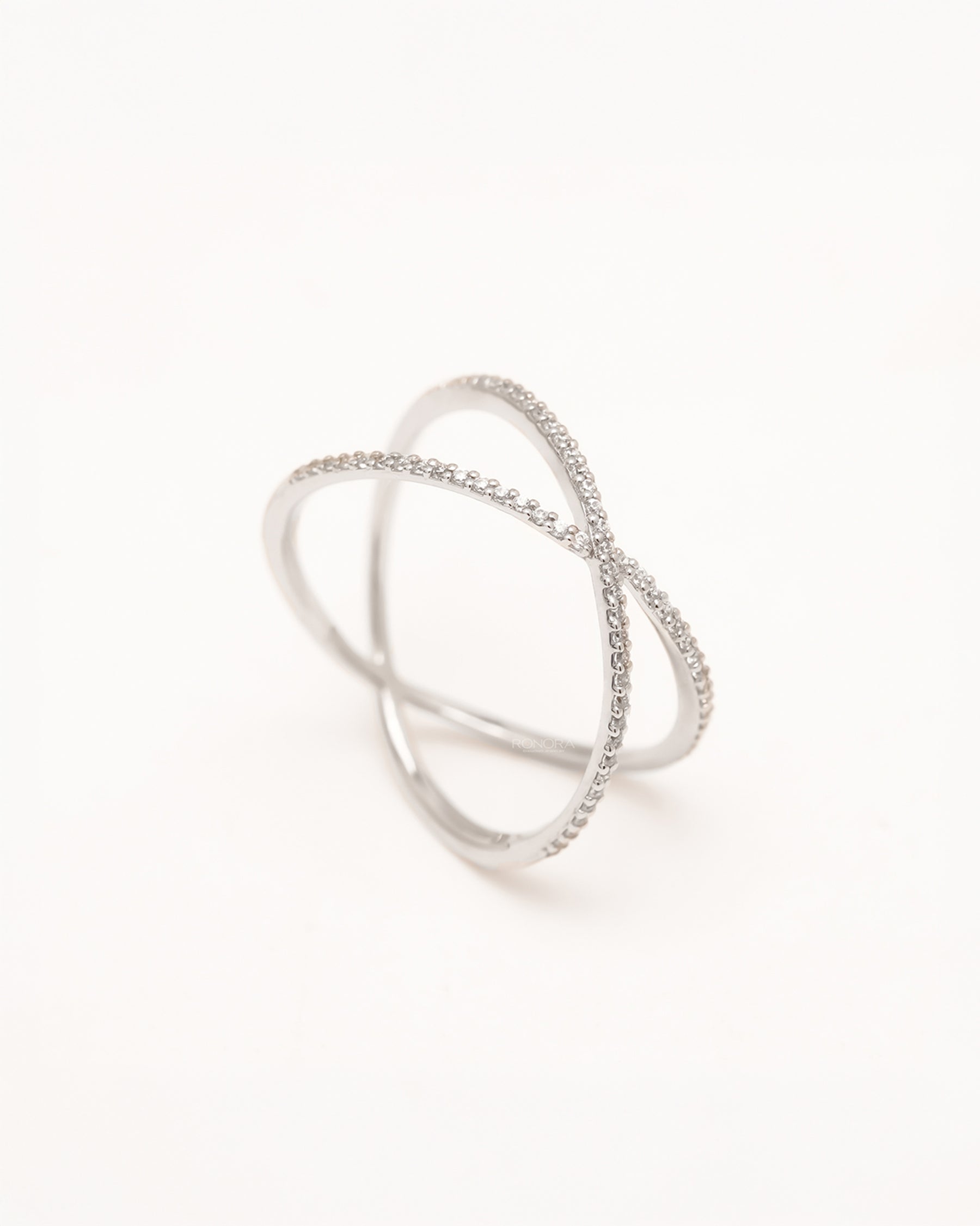 Back view of white lab grown diamond crossover ring showing sculptural open band