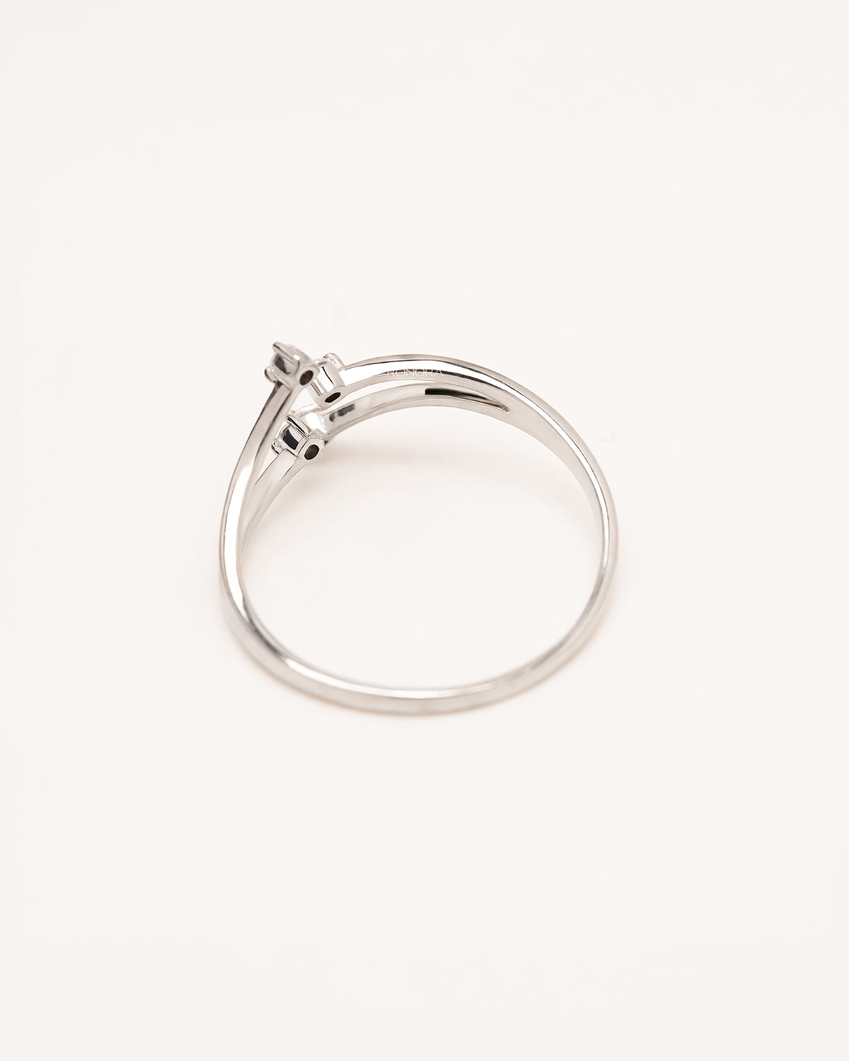 Back view of four-stone lab grown diamond bypass ring showing open curved shank