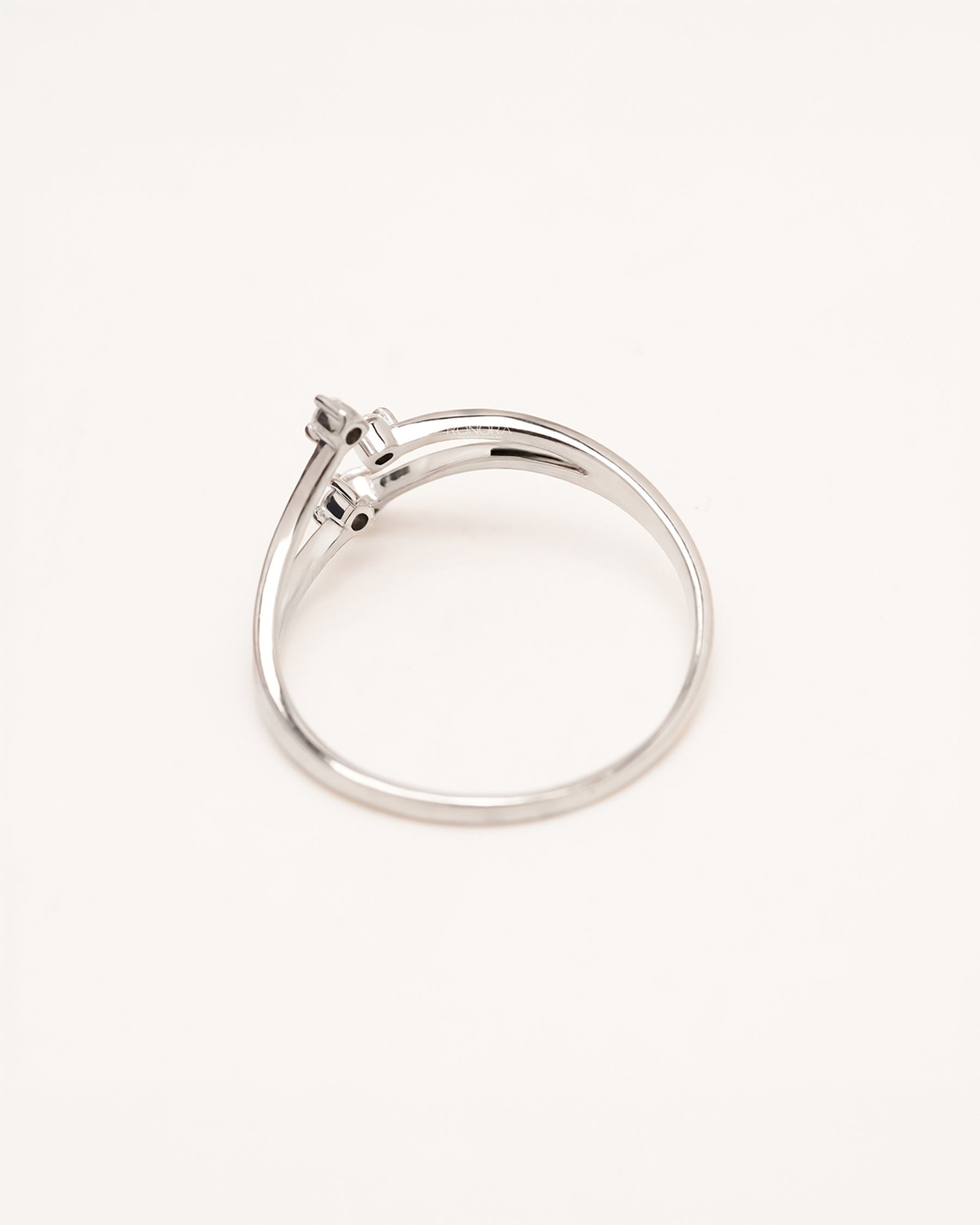 Back view of four-stone lab grown diamond bypass ring showing open curved shank