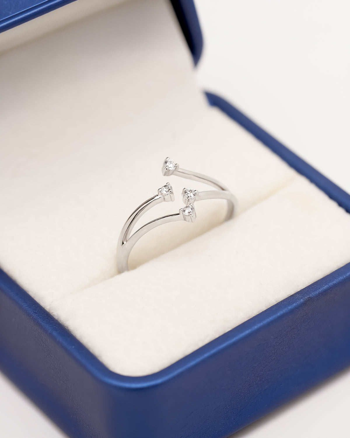 Elara four-stone lab grown diamond bypass ring in white metal inside Ronora box