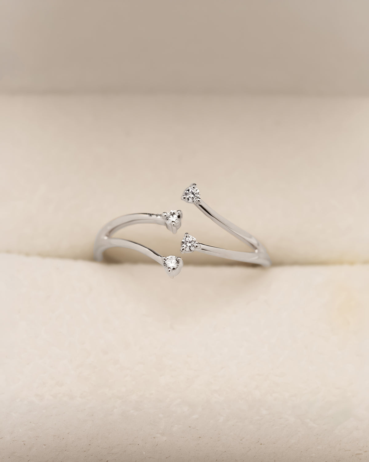 Open bypass lab grown diamond ring with four round diamonds and slim curved band