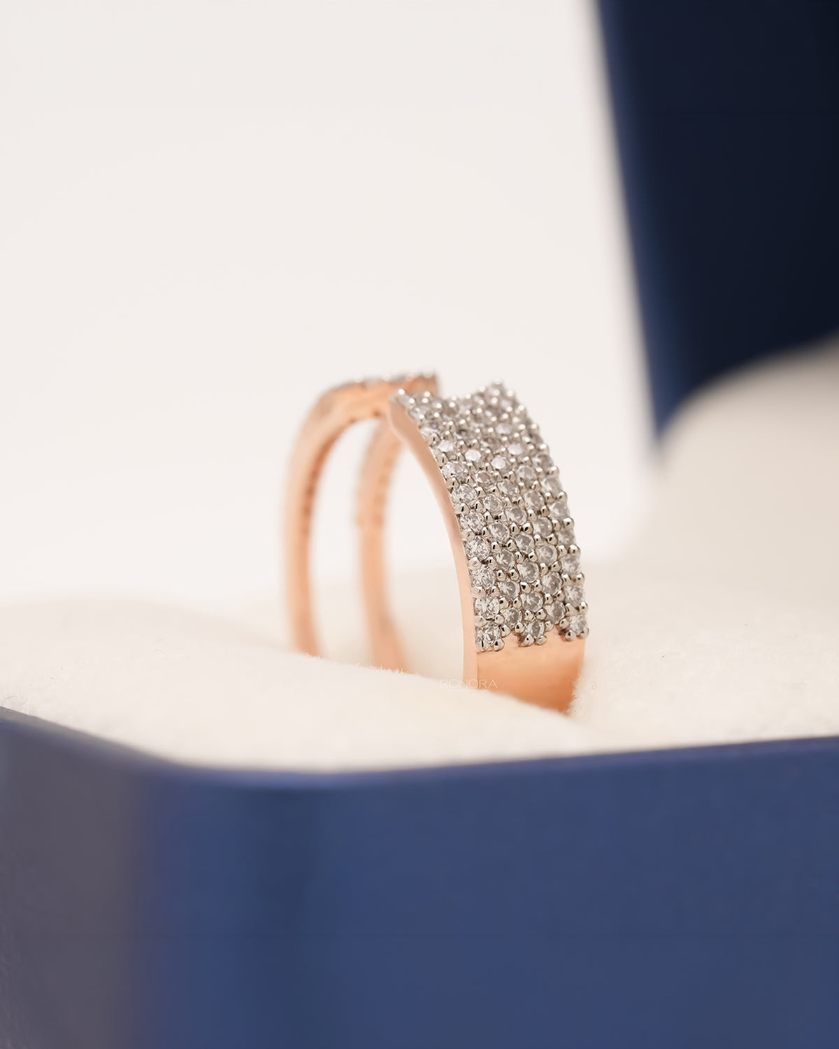 Side profile of rose gold open pavé statement ring showing wide diamond panel