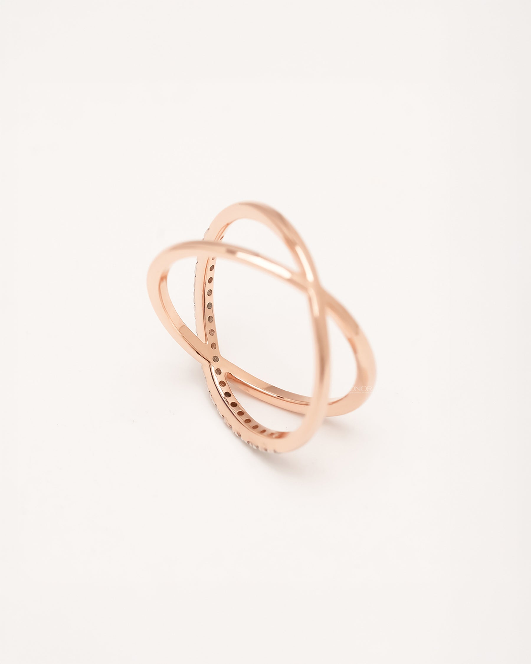 Angled view of rose gold crossover ring with round pavé lab grown diamonds