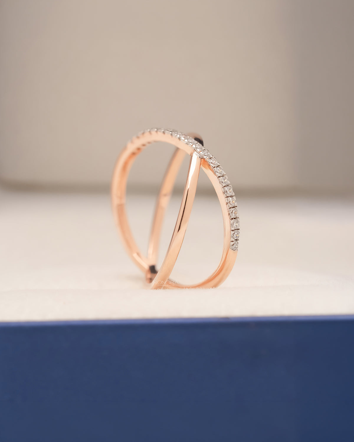 Side profile of rose gold twisted pavé lab grown diamond ring showing open crossover bands
