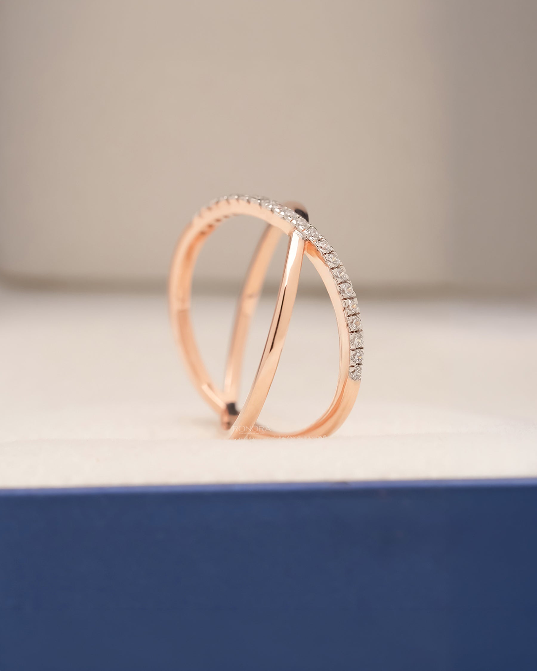 Side profile of rose gold twisted pavé lab grown diamond ring showing open crossover bands