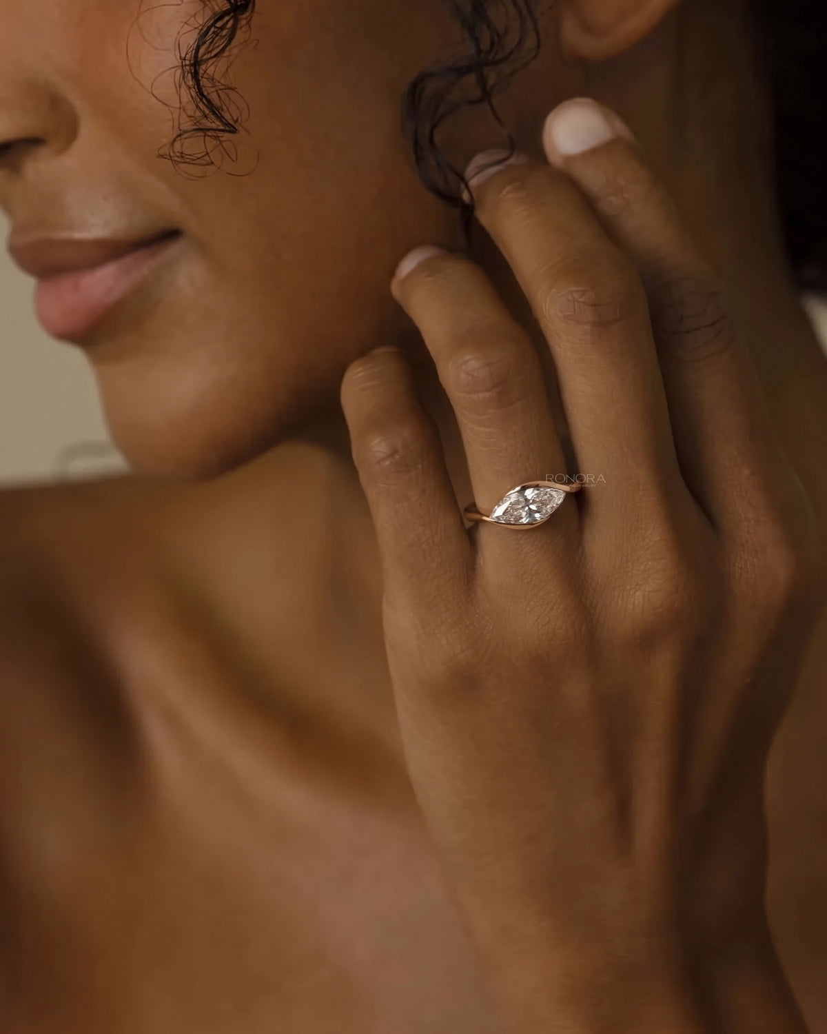 Model wearing the marquise bezel lab grown diamond ring in yellow gold
