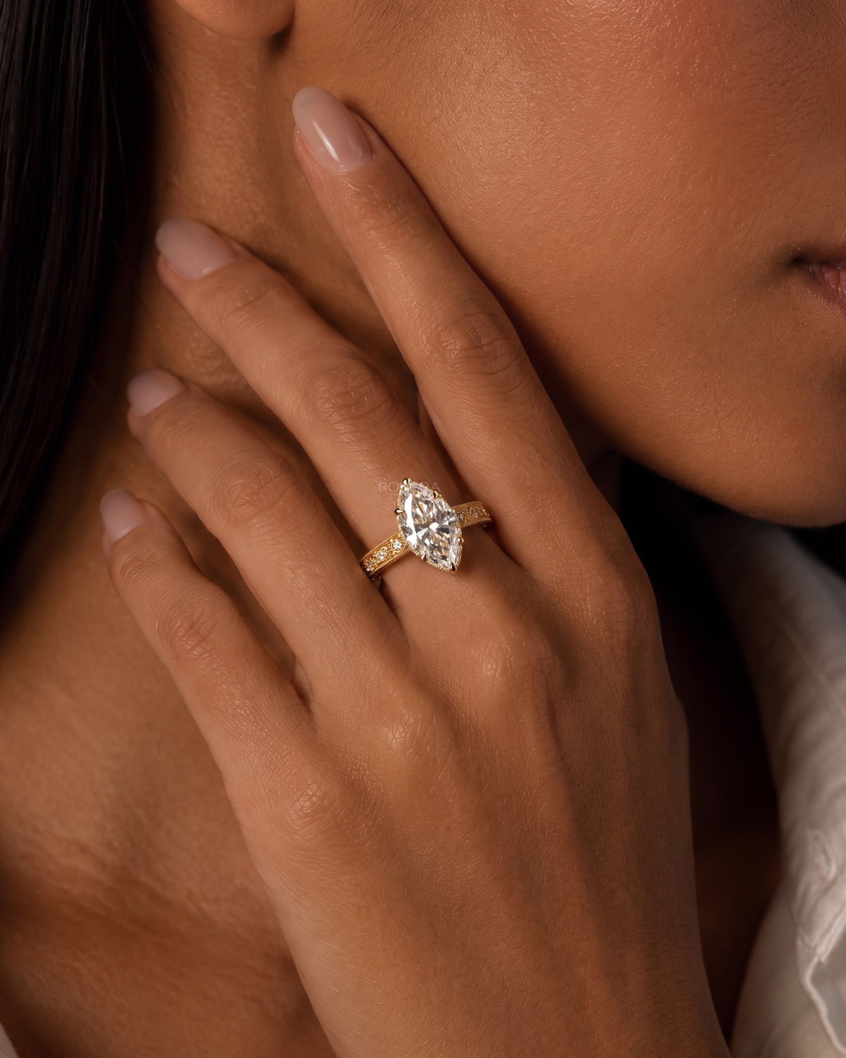 Model wearing the vintage marquise lab grown diamond ring in yellow gold