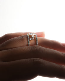 Side profile of a baguette lab grown diamond cluster ring worn on a finger, two pave rows with scattered baguettes
