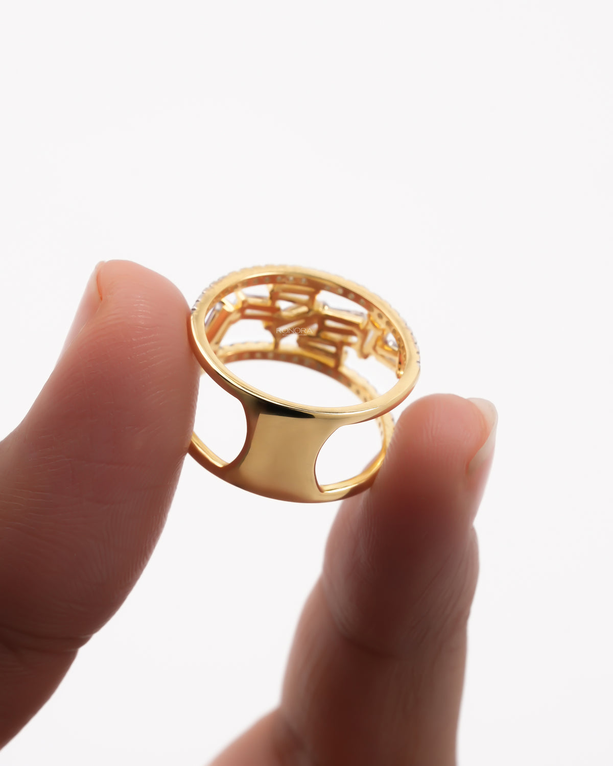Back view of a yellow gold baguette lab grown diamond cluster ring showing the open cutout band design