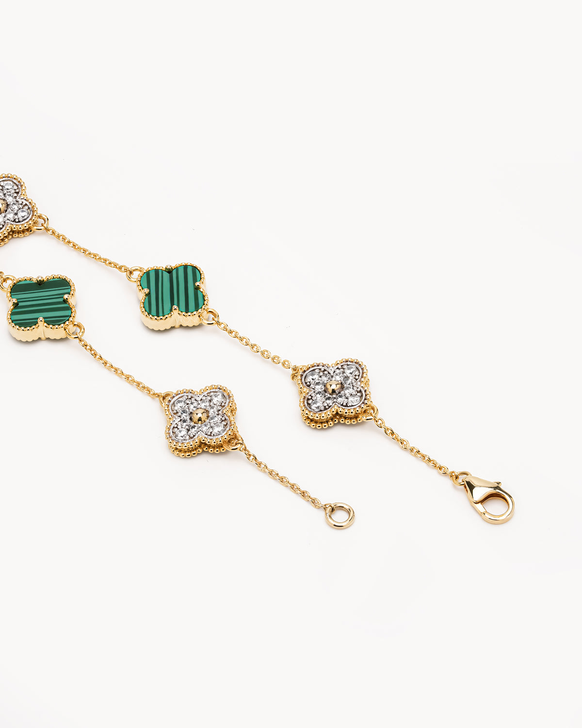 Clover malachite bracelet laid flat showing alternating green and pave clover motifs