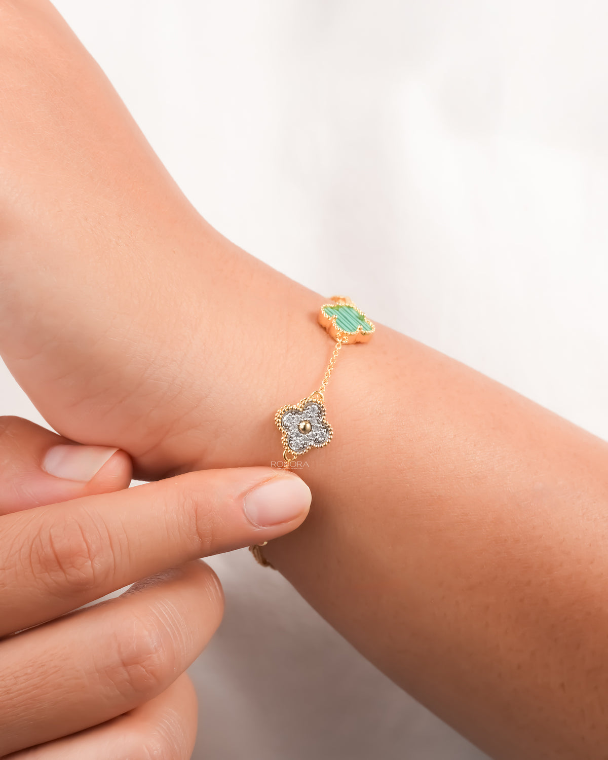 Clover malachite bracelet on the wrist showing the pave diamond clover