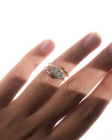 Dutch marquise lab grown diamond ring in rose gold worn on a finger, east west bezel setting with bypass band