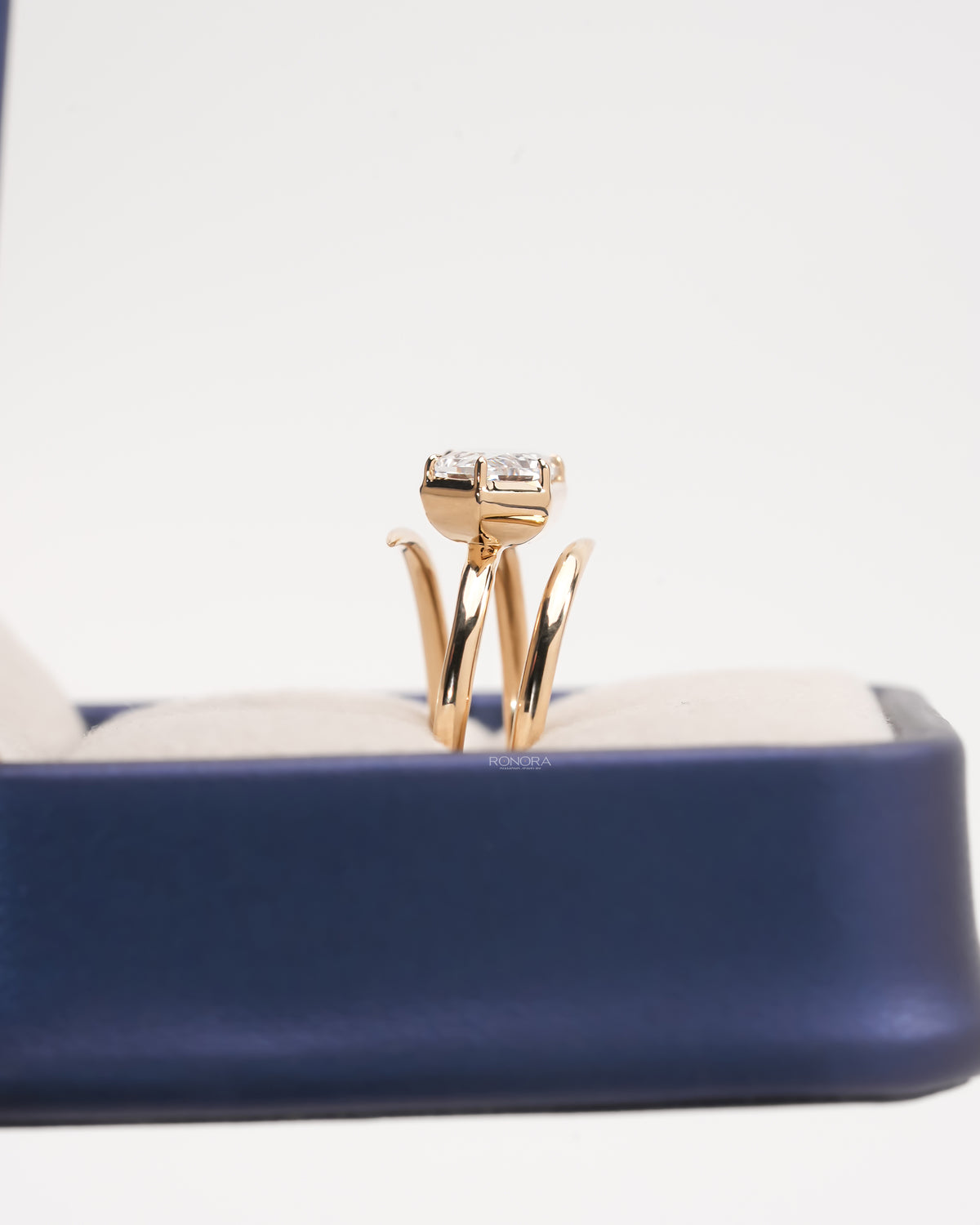 Side view of a Dutch marquise lab grown diamond ring in rose gold showing the double bypass band in a ring box