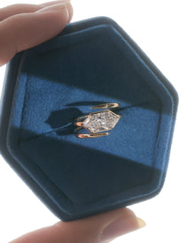 Dutch marquise lab grown diamond ring in rose gold inside a blue velvet ring box held in hand
