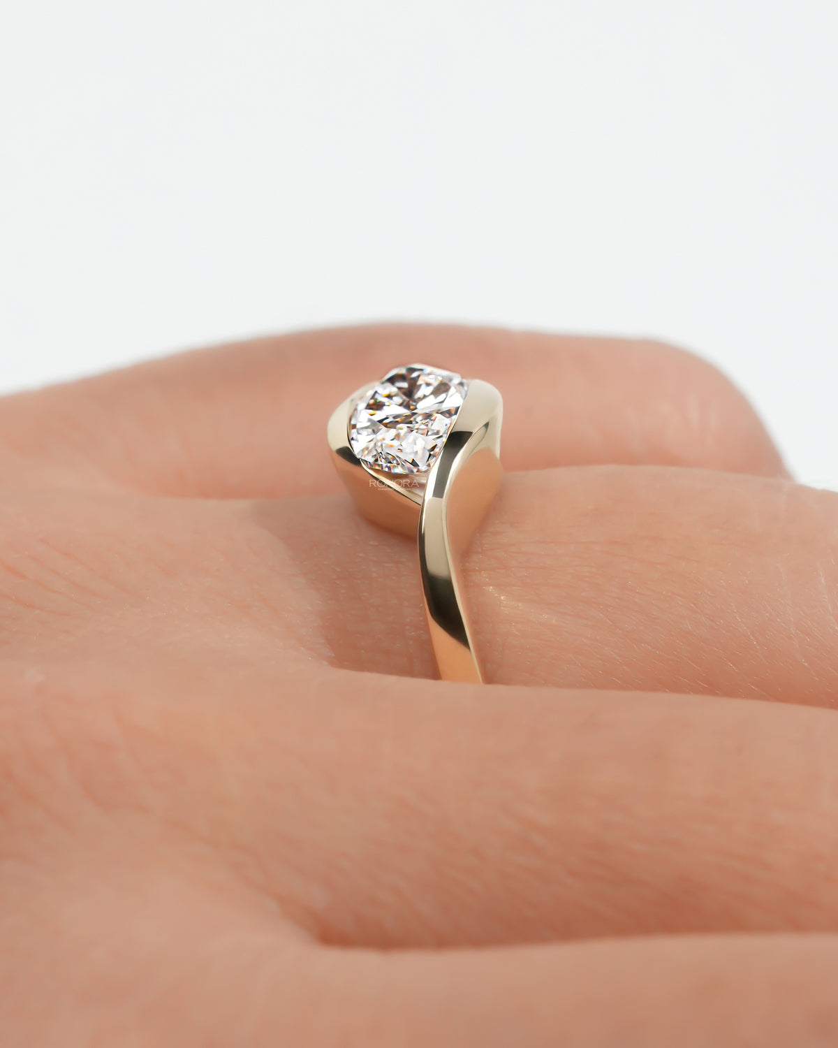Marquise bezel lab grown diamond ring worn at an angle on the hand