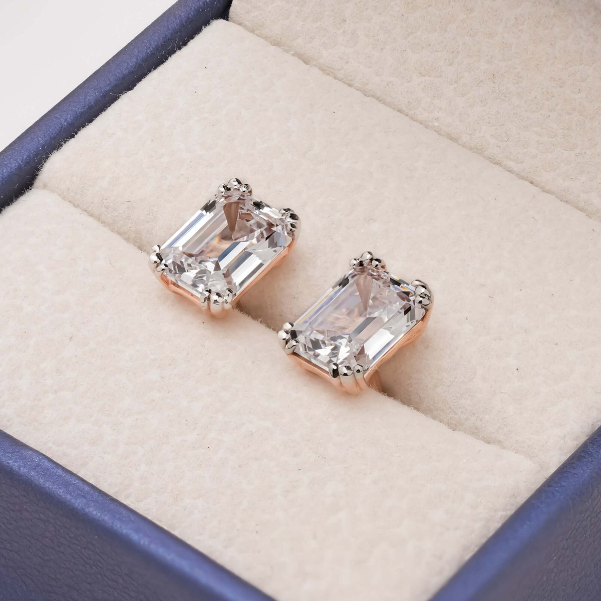 Emerald cut lab grown diamond stud earrings in 14K rose gold inside Ronora box