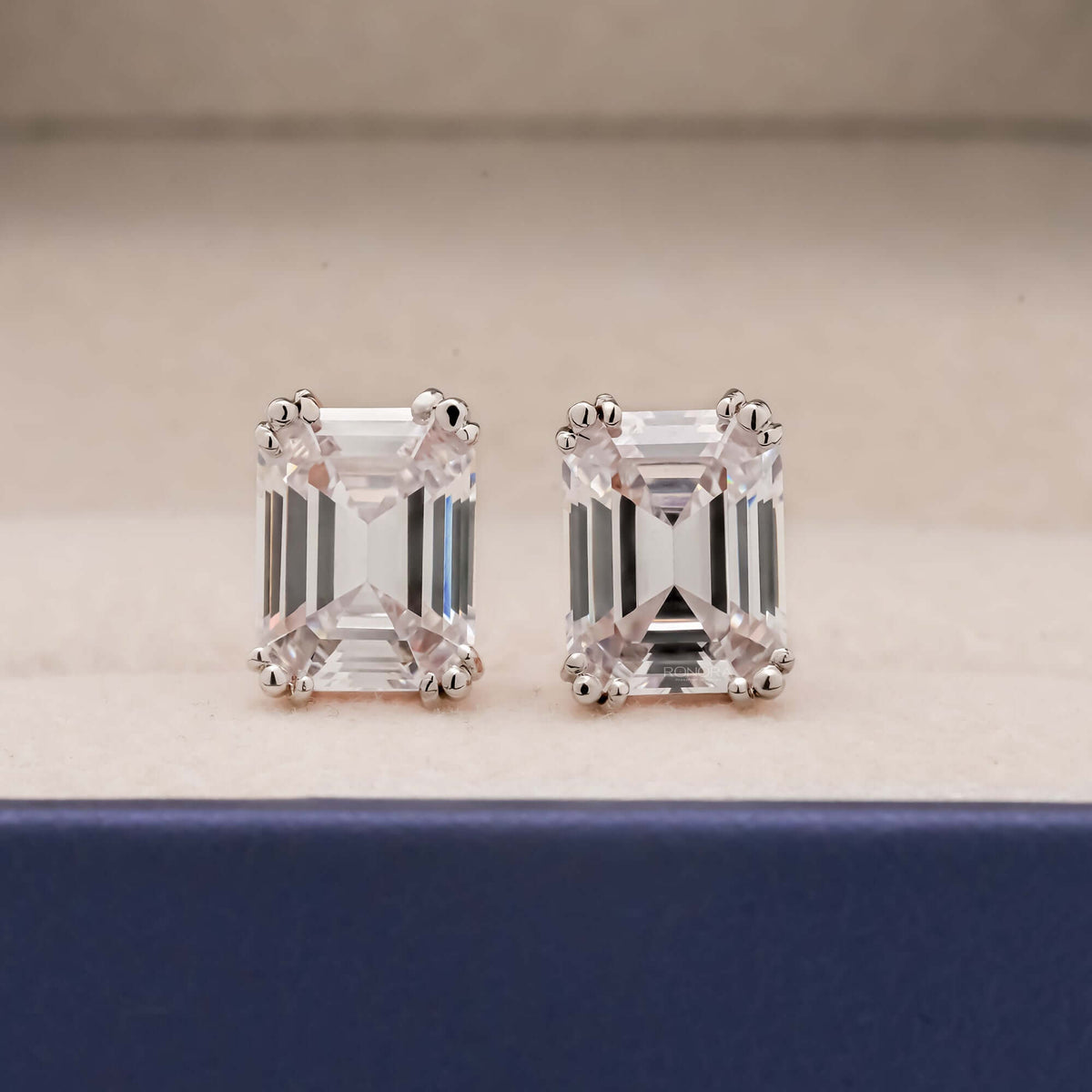 Emerald cut lab grown diamond stud earrings prong basket setting front view