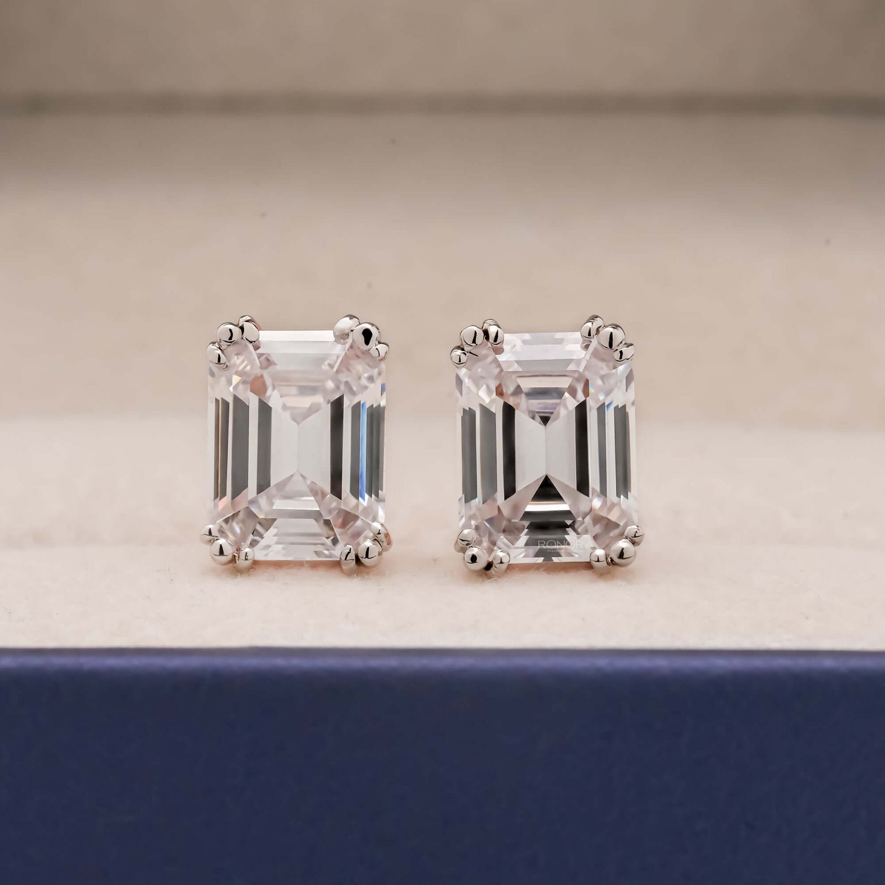Emerald cut lab grown diamond stud earrings prong basket setting front view