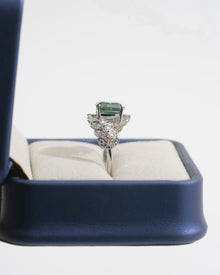 Side view of a green cushion lab grown diamond engagement ring in white gold with a leaf sprig diamond band