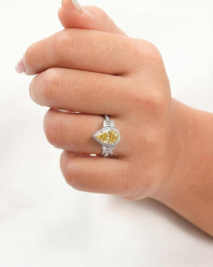 yellow pear lab grown diamond halo ring worn on hand in white gold