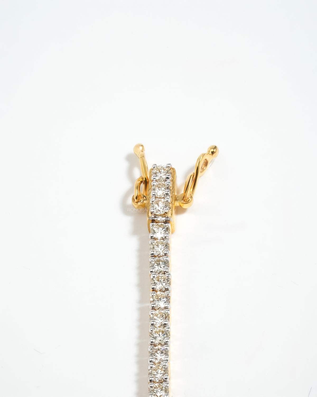 Vertical view of a lab grown diamond tennis bracelet box clasp and round diamonds in yellow gold on white