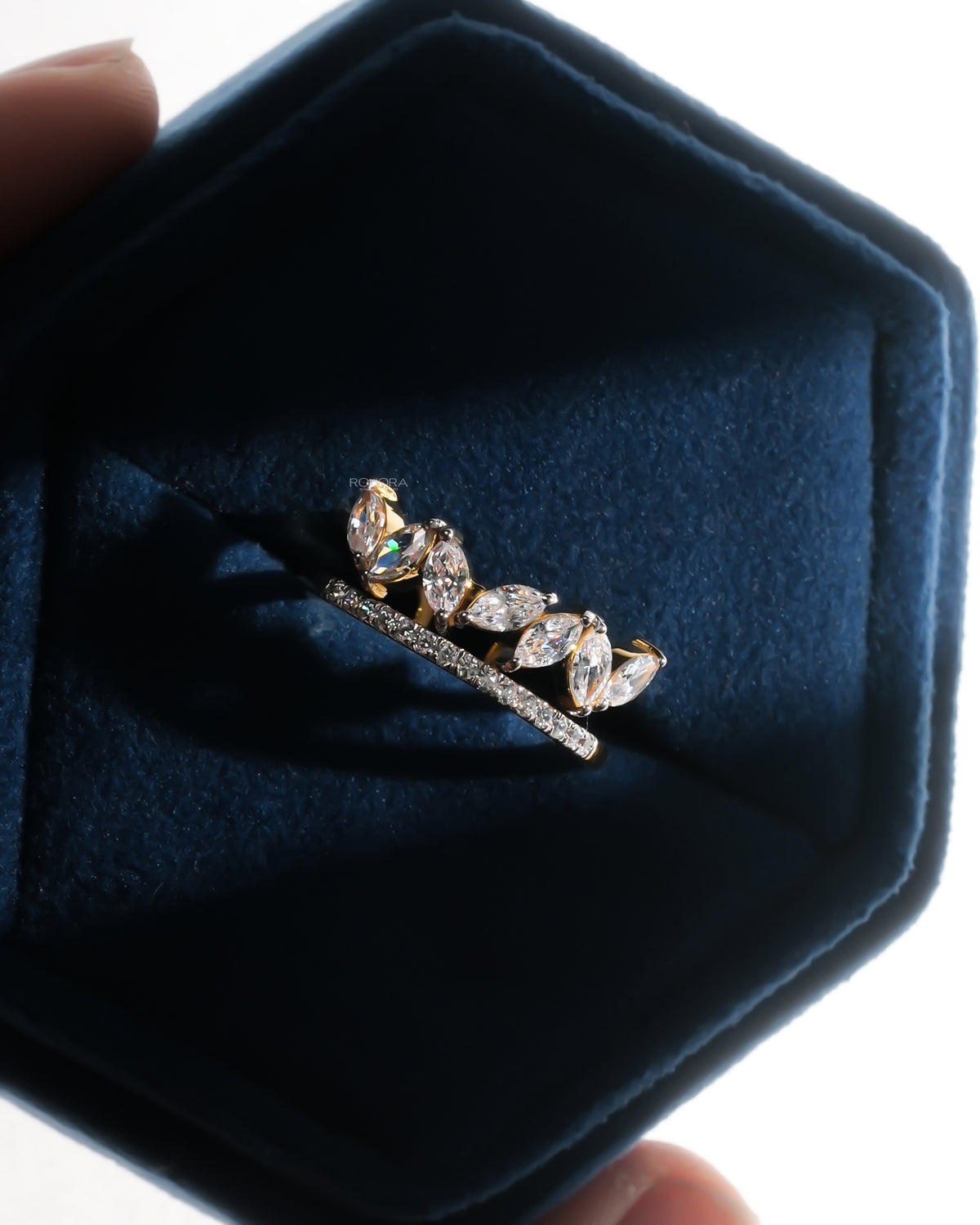 Marquise lab grown diamond leaf wrap ring in yellow gold with a pave band, resting in a navy velvet ring box