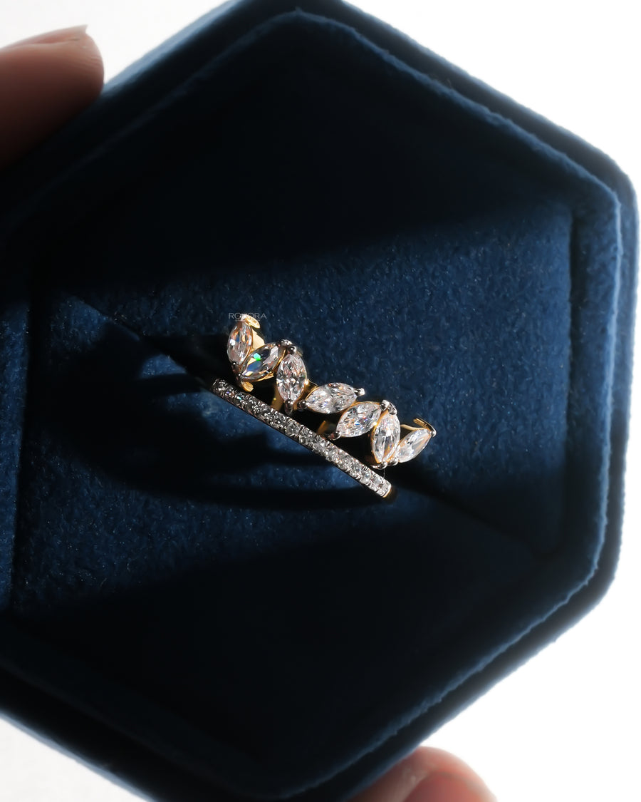 Marquise lab grown diamond leaf wrap ring in yellow gold with a pave band, resting in a navy velvet ring box