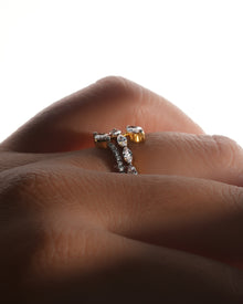 Marquise lab grown diamond vine ring worn on a finger, side view with a snake wrap band in soft backlight