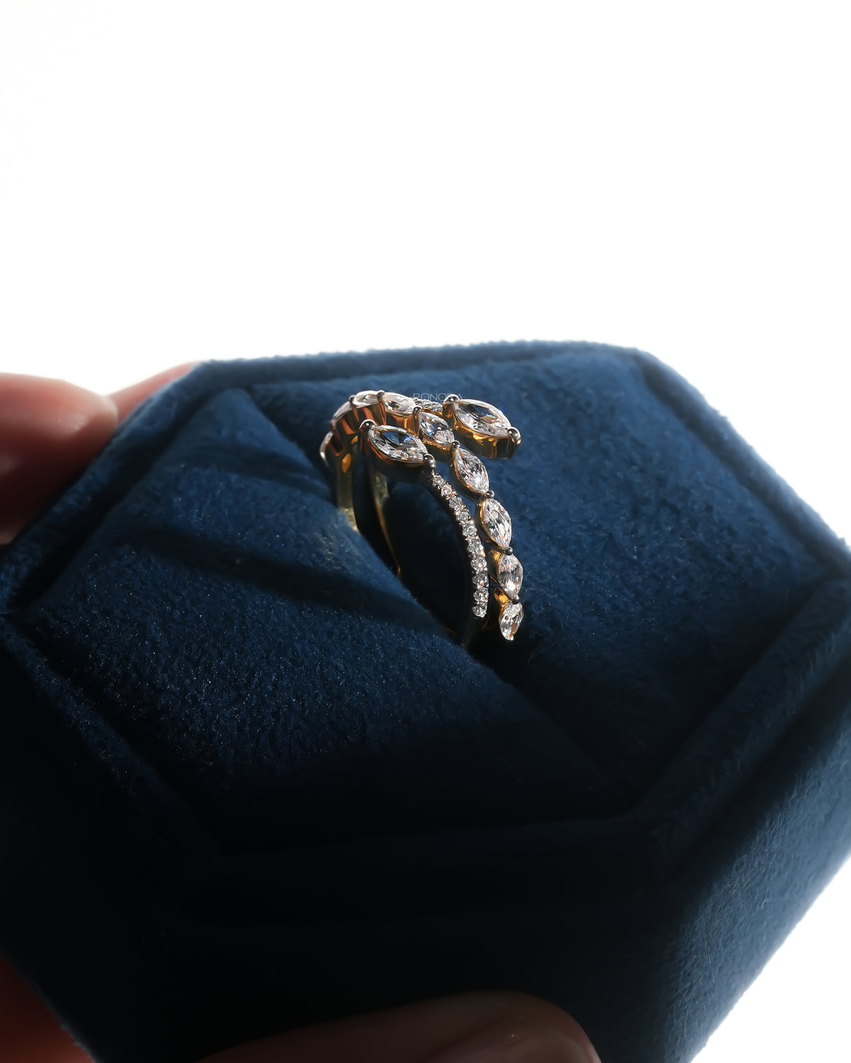 Marquise lab grown diamond vine ring in yellow gold standing in a blue velvet ring box, side angle view
