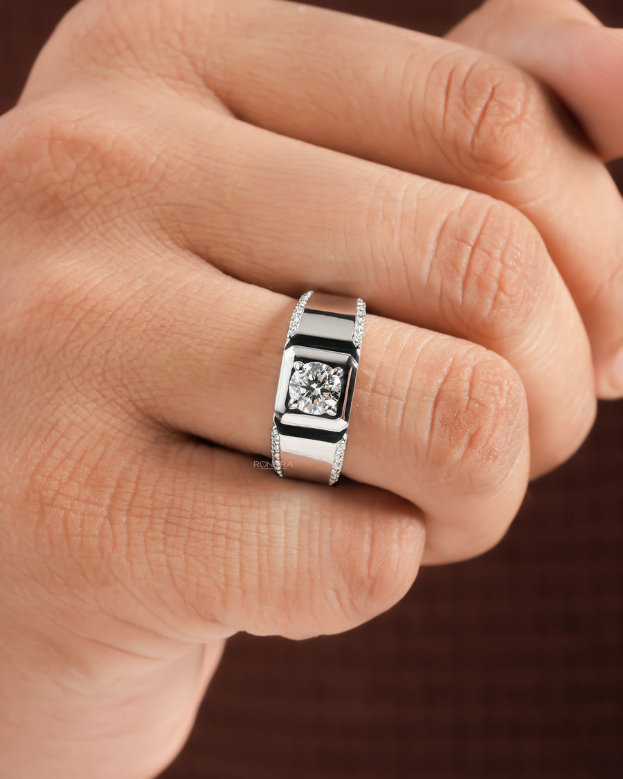 Man's hand wearing a men's round lab grown diamond ring with a wide white gold pave band, front view