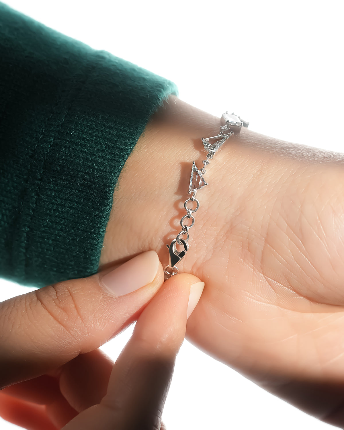 Fastening the clasp of the multi shape lab grown diamond bracelet on the wrist