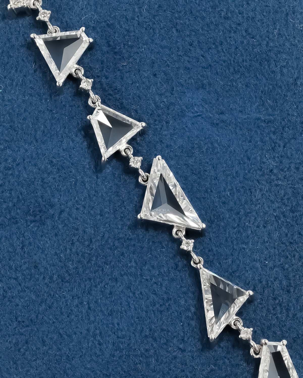 Close-up of the multi shape lab grown diamond bracelet on blue velvet