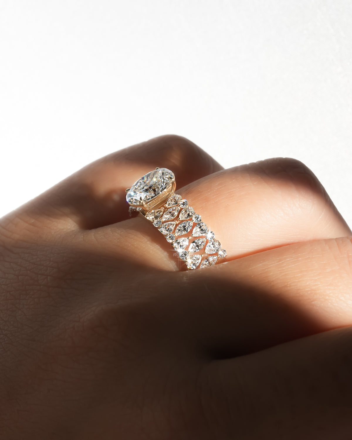 Oval cluster lab grown diamond ring on the finger showing the raised centre stone