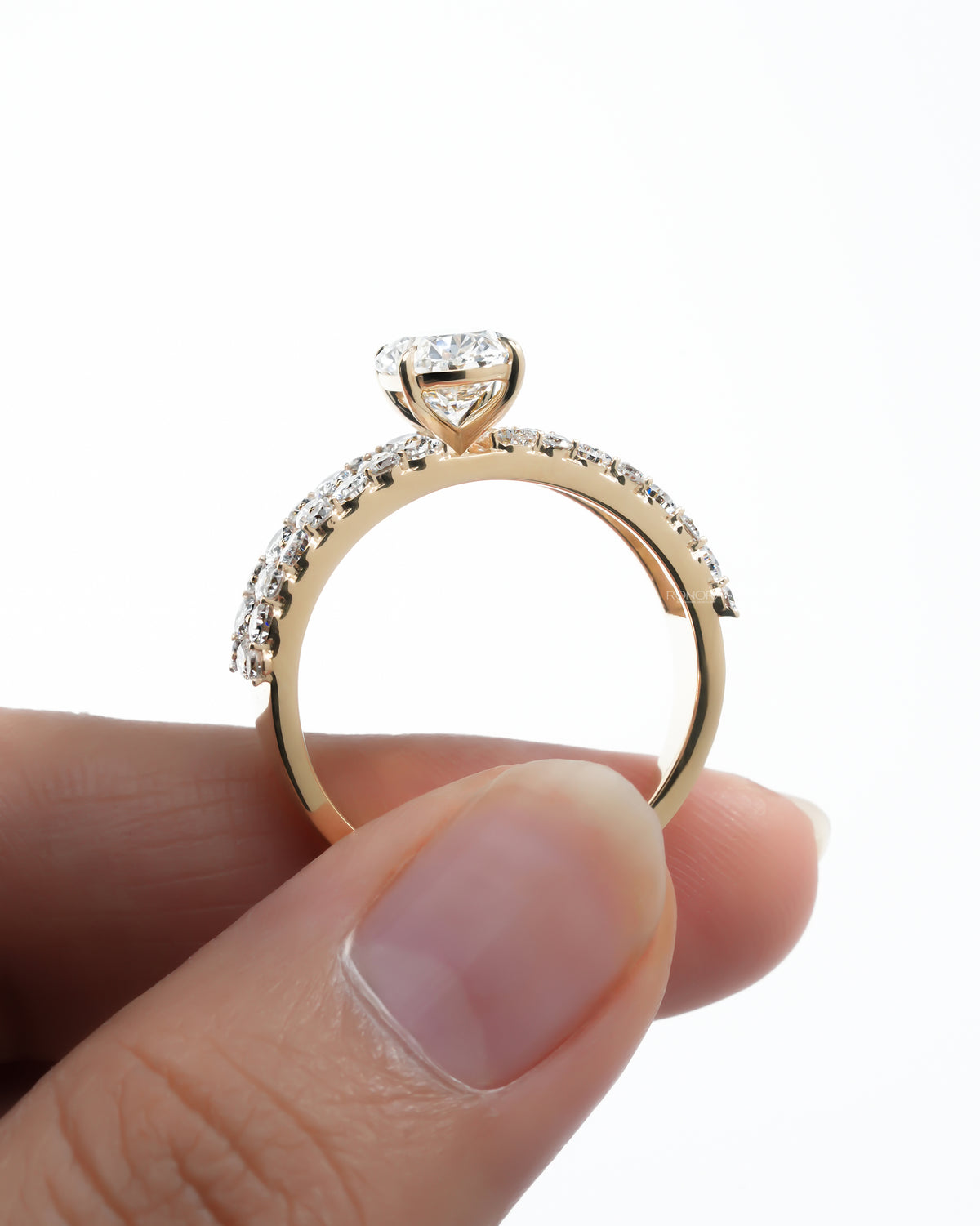 Side profile of the oval cluster lab grown diamond ring showing the gallery and band