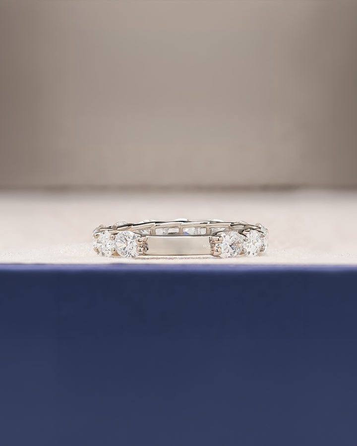 Side profile of oval lab grown diamond eternity band showing ring setting