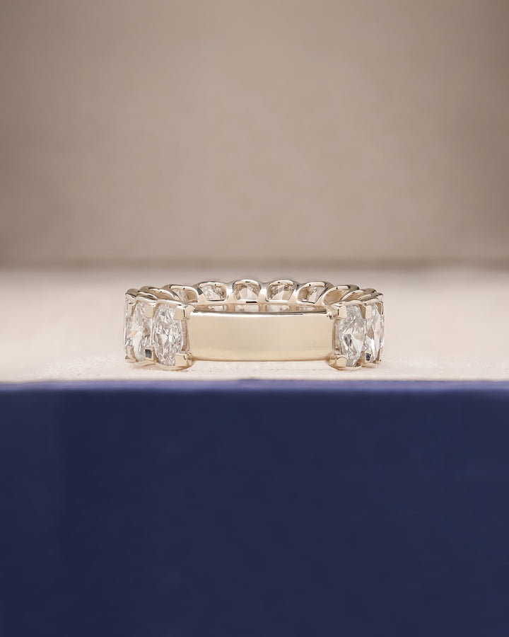 Side profile of full oval lab grown diamond eternity band showing ring setting