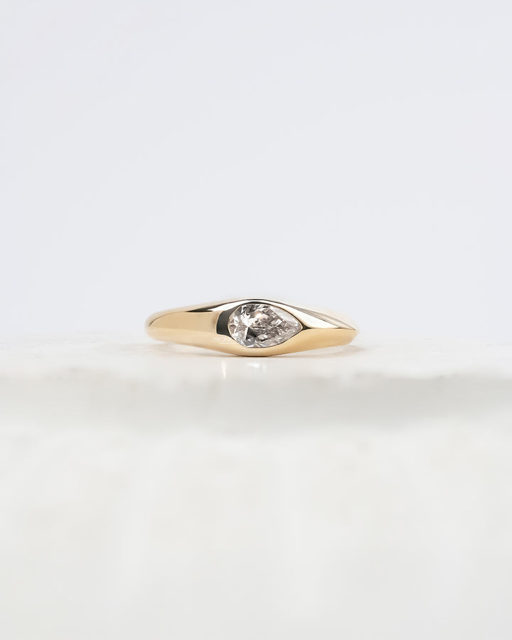 Mabelle pear lab grown diamond bezel ring in yellow gold inside Ronora box