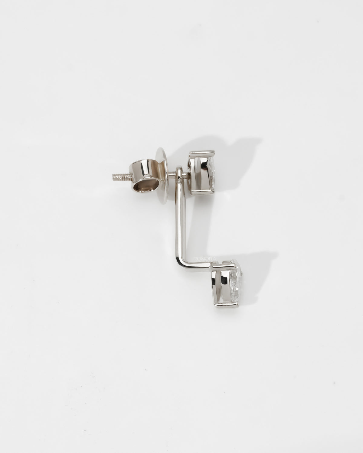 Side view of a pear lab grown diamond ear jacket earring in white gold showing the stud, jacket and screw back