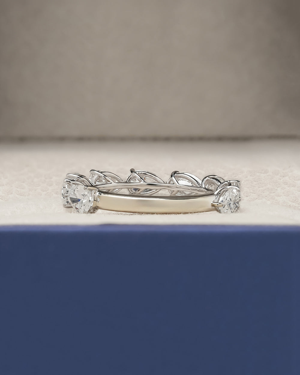 Side profile of pear lab grown diamond eternity band showing ring setting