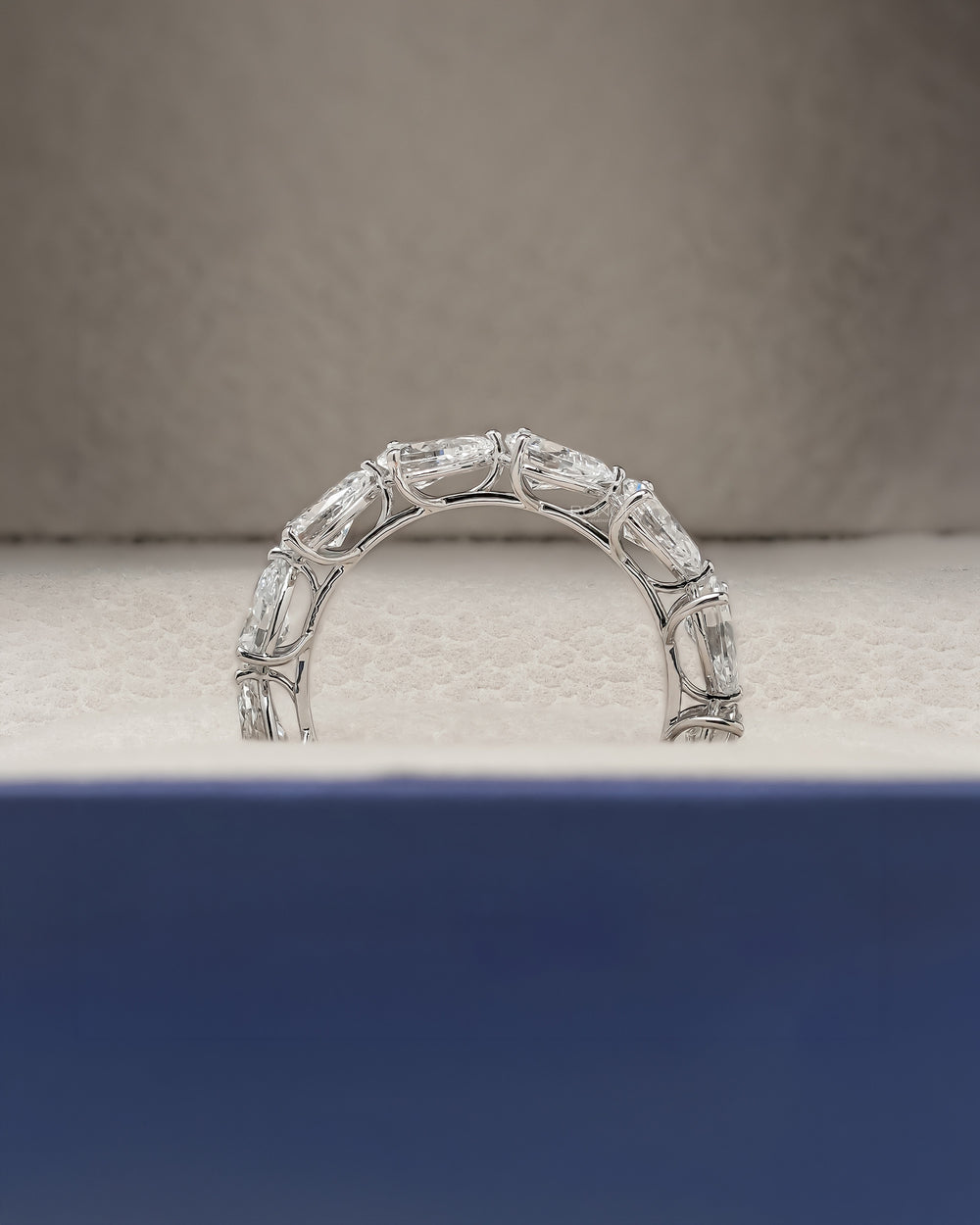 Angled view of pear lab grown diamond eternity band with eternity setting