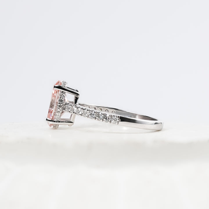 pink oval lab grown diamond halo ring worn with luxury styling in white gold