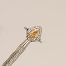 Close-up video of yellow pear lab grown diamond halo ring in white metal