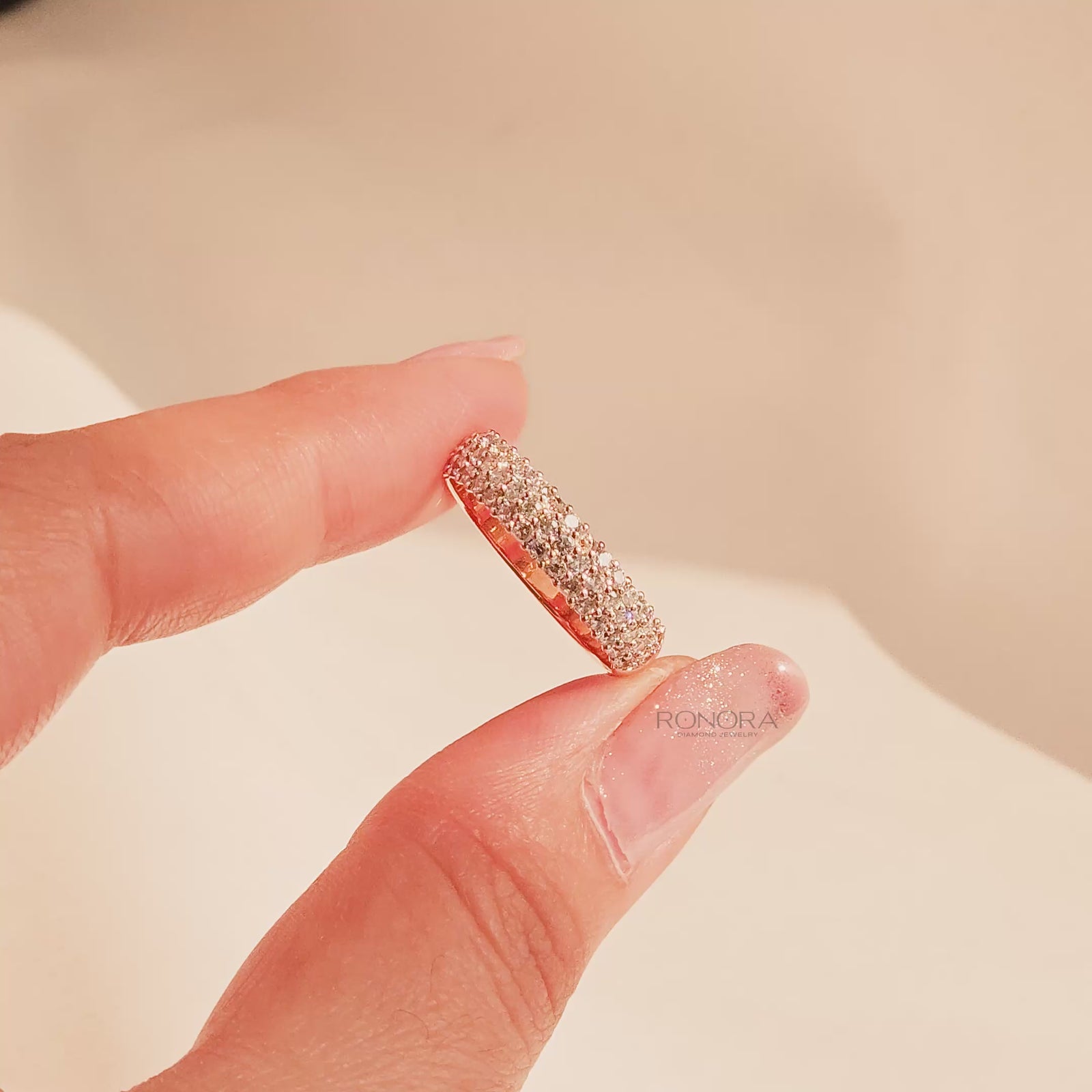 Close-up video of wide lab grown diamond pavé band in rose gold