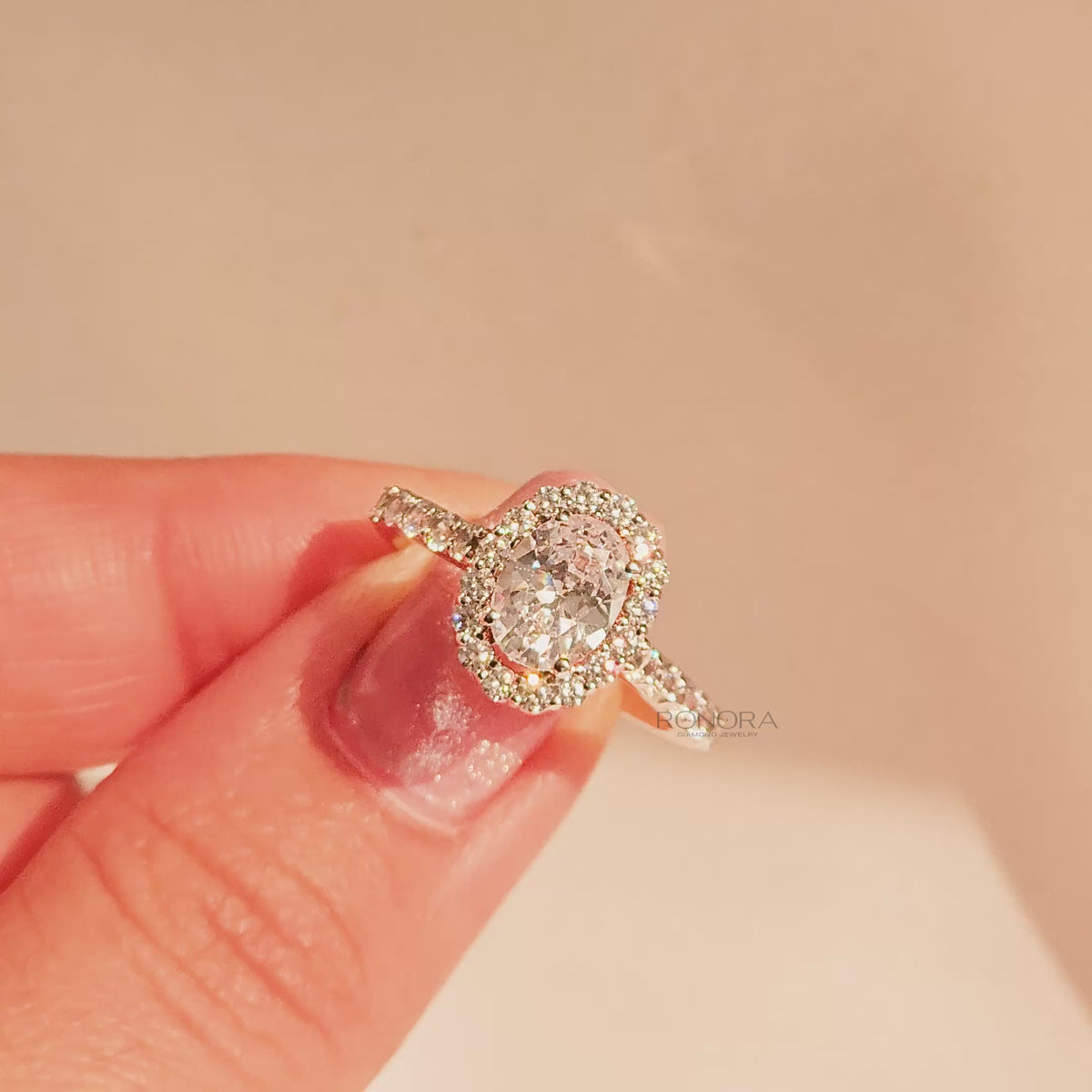 Close-up video of oval moissanite halo ring in rose gold